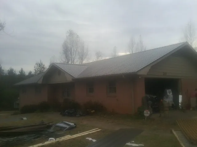 Gray metal roof on a stucco house with an attached garage in Vail
